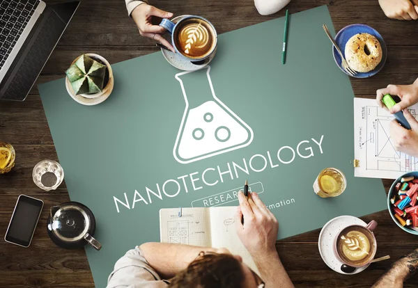 Table with poster with Nanotechnology concept — Stock Photo, Image