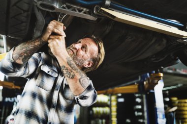 car mechanic repairing automobile clipart