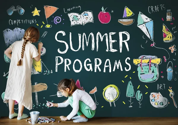 Cute sisters drawing on blackboard — Stock Photo, Image