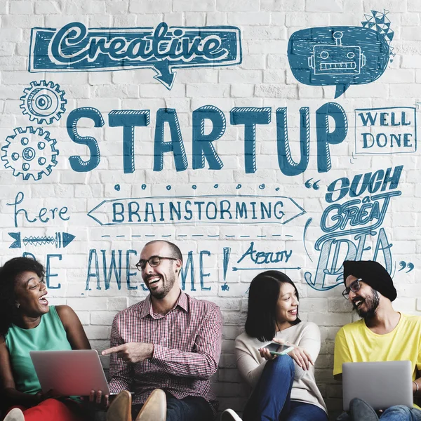 Diversity friends near wall with Startup — Stock Photo, Image