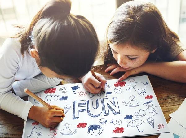 Cute sisters drawing at coloring-book — Stock Photo, Image