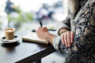 man writing notes with coffee clipart