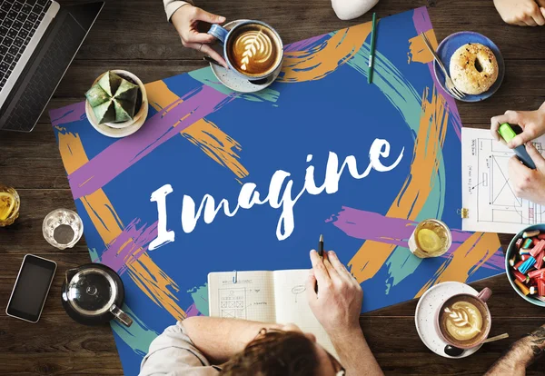 Mesa con póster con concepto imagine —  Fotos de Stock