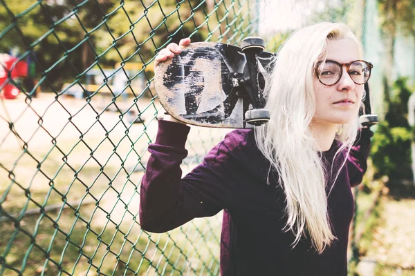 Skateboarder girl holding skate — Stock Photo, Image