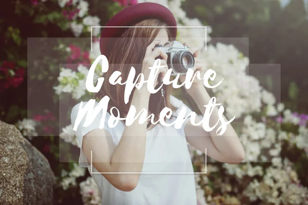 Woman with camera surrounded by flowers — Stock Photo, Image