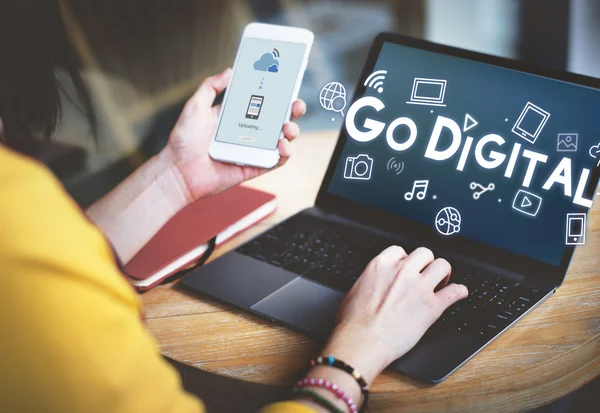 Woman with laptop and phone — Stock Photo, Image