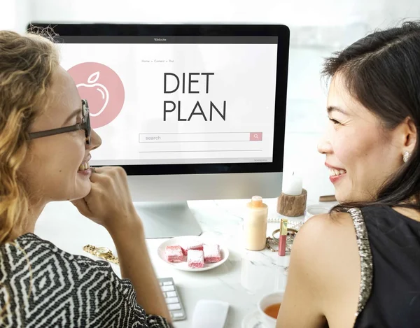 Women talking and using computer — Stock Photo, Image