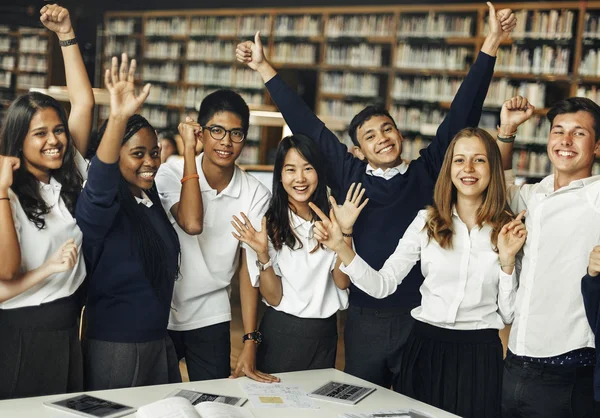 Happy students in university library — Stock Photo, Image