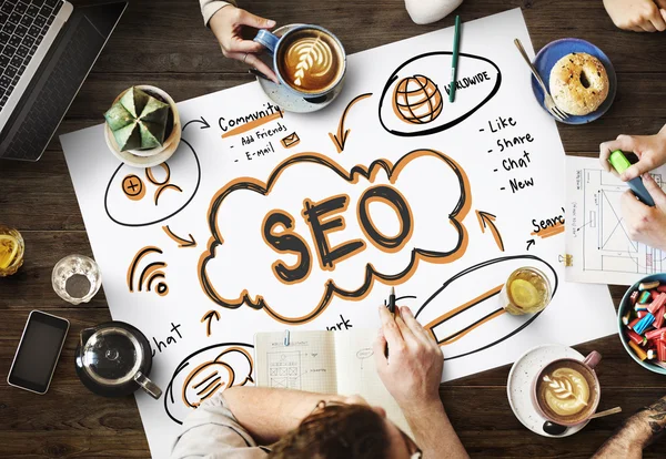 Table with poster with SEO concept — Stock Photo, Image