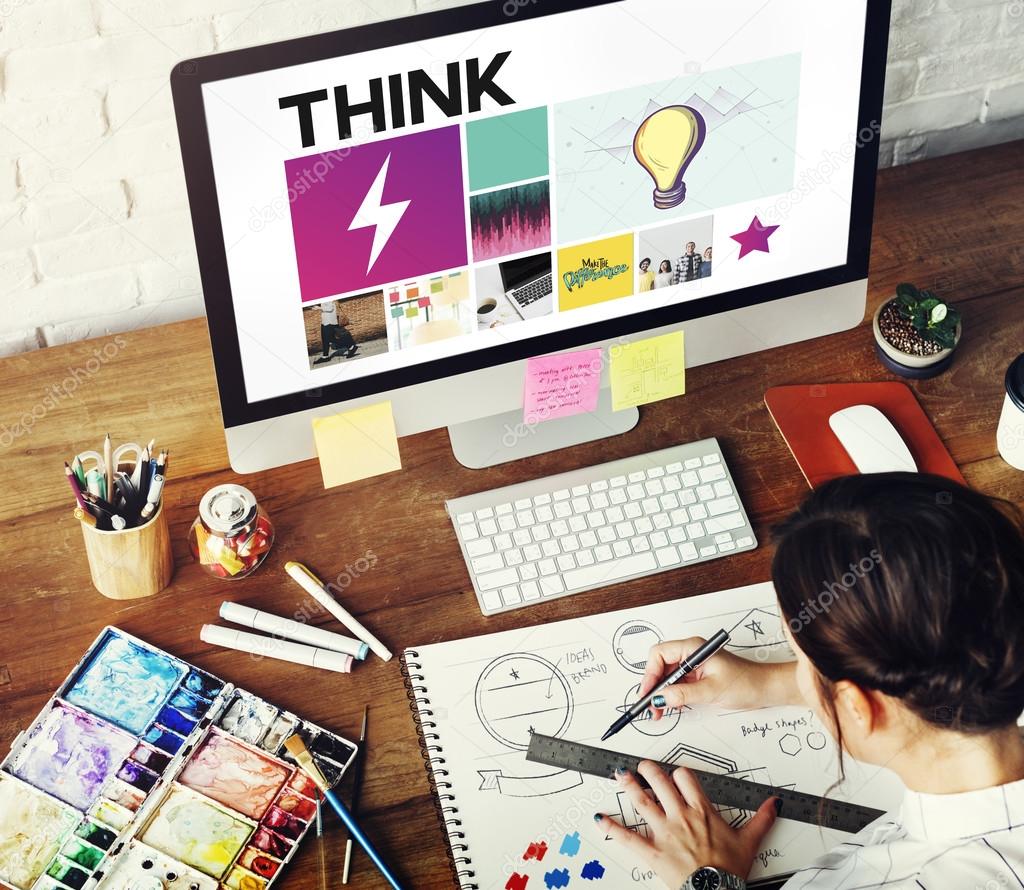Creative woman drawing in album, computer monitor with text: Think