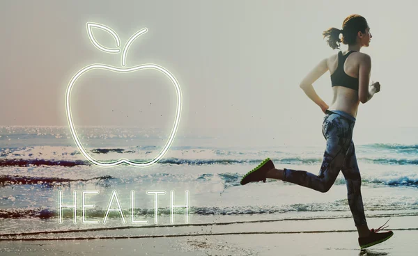 Woman in leggings running on beach — Stock Photo, Image