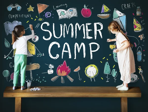 Cute sisters drawing on blackboard — Stock Photo, Image