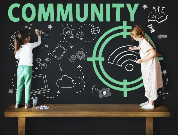 Cute sisters drawing on blackboard — Stock Photo, Image