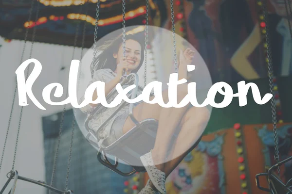 Girl riding on swing in Amusement Park — Stock Photo, Image