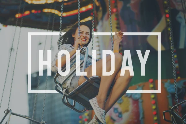 Girl riding on swing in Amusement Park — Stock Photo, Image