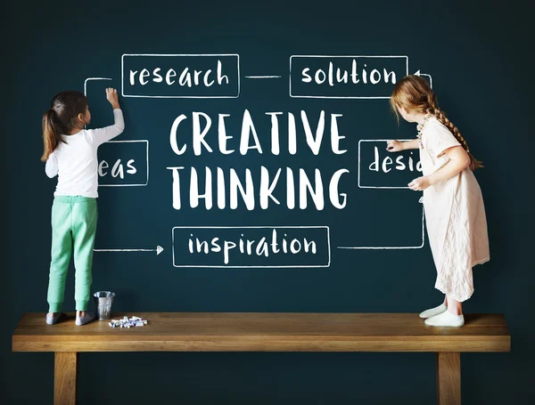 Cute sisters drawing on blackboard — Stock Photo, Image