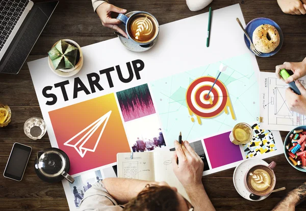 Table with poster with Startup — Stock Photo, Image