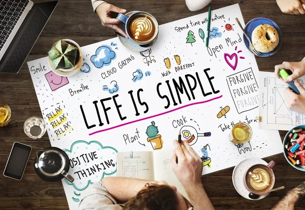 Table with poster with Life Is Simple — Stock Photo, Image