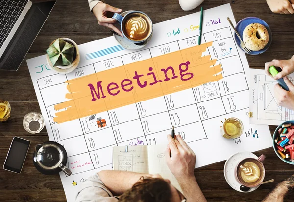 Mesa com cartaz com reunião — Fotografia de Stock