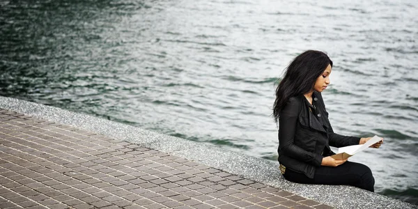 African woman sit near river — Stock Photo, Image