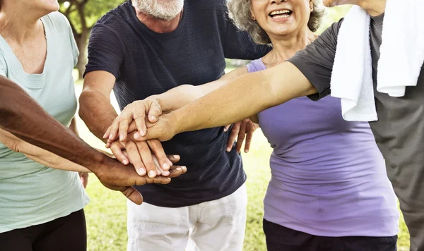 Senior friends shaking hands — Stock Photo, Image