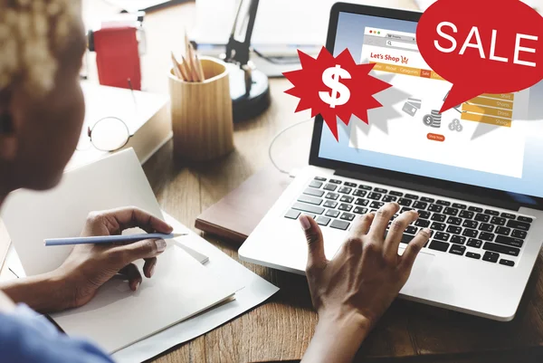 Woman working on laptop with sale — Stock Photo, Image