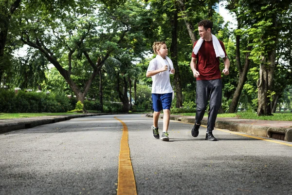 Boy and Trainer Jogging outdoors