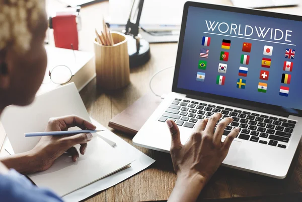 Woman working on laptop with Worldwide — Stock Photo, Image