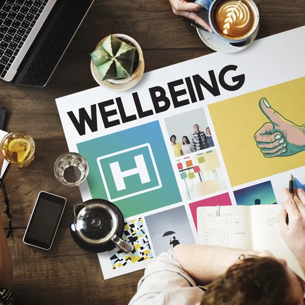 Table with poster with Wellbeing concept — Stock Photo, Image