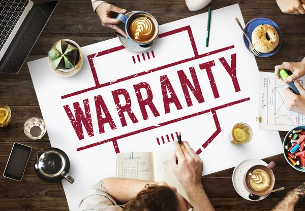 Table with poster with Warranty — Stock Photo, Image