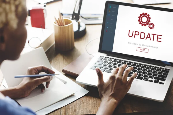 Woman working on laptop with Update — Stock Photo, Image