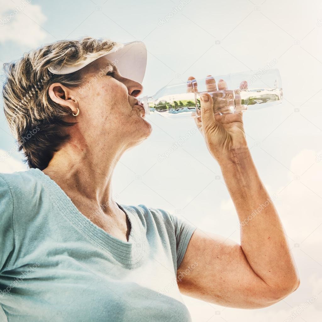 Senior woman drinking water