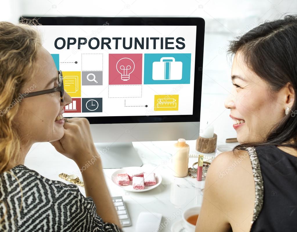 women talking and using computer