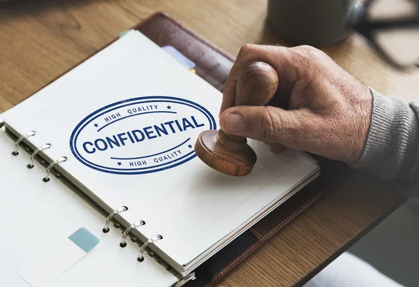 Stamp in notebook with Confidential — Stock Photo, Image