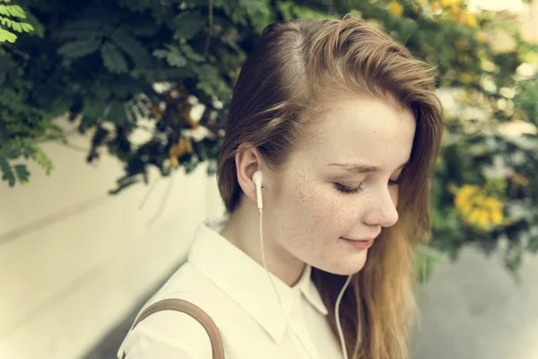 Menina ouvindo música em fones de ouvido — Fotografia de Stock