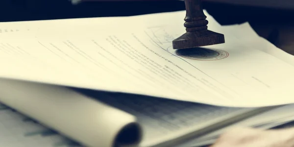 Wooden stamp on workplace table — Stock Photo, Image