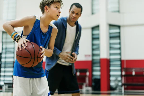 Treinador e menino jogando basquete — Fotografia de Stock