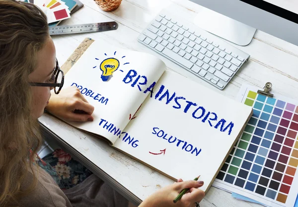 Woman with sketch-book in office — Stock Photo, Image