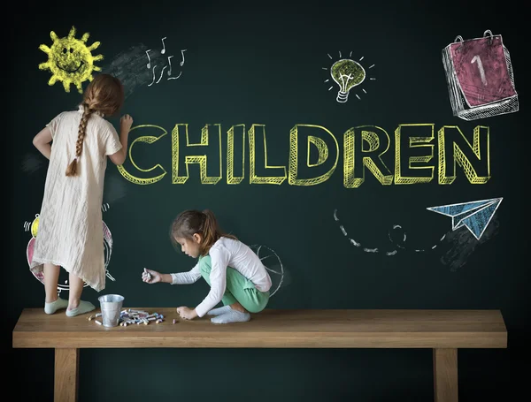 Children drawing on blackboard — Stock Photo, Image