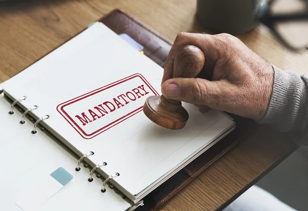 Stempel in notitieboekje met verplicht — Stockfoto