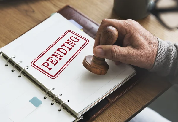 Carimbo no caderno com pendente — Fotografia de Stock