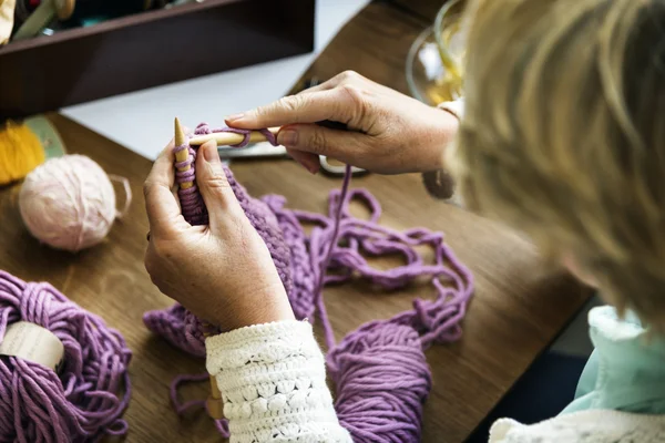 woman knitting at home