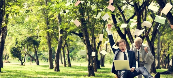 Businessman and Businesswoman with laptop at park — Stock Photo, Image