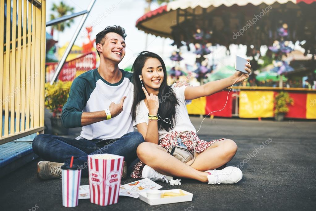 Couple making selfie in amusement park