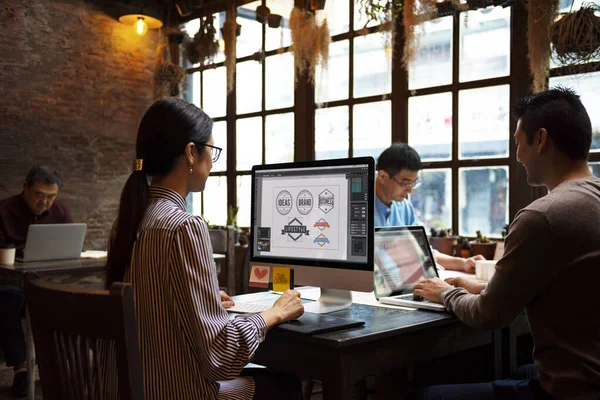 Group of designers working together in a cafe