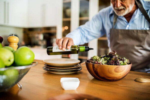 White Haired Guy Preparing Salad Bowl Stock Picture