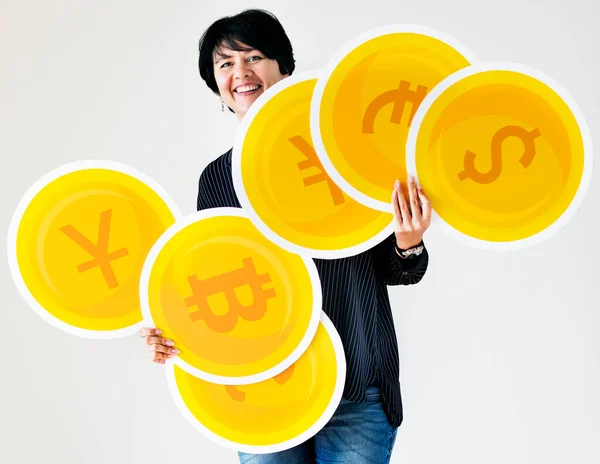 Woman Carrying Different Currency Coin Icons — стоковое фото