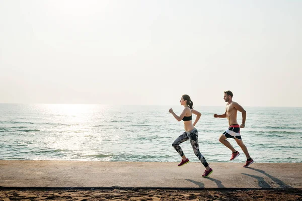 Healthy Young Couple Running Beach Together — Foto Stock