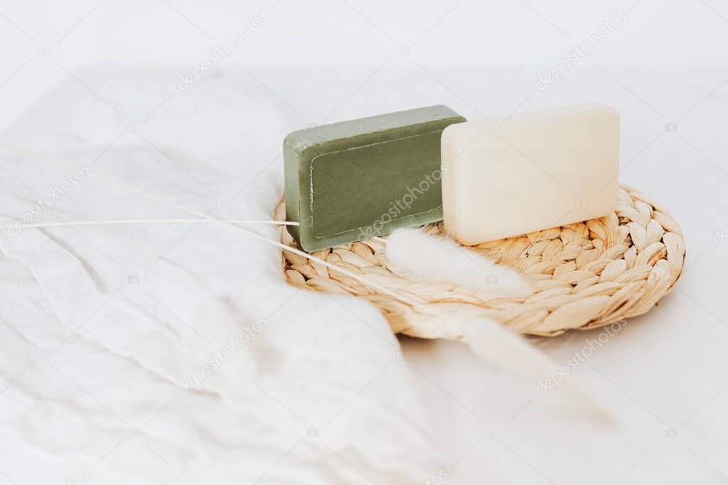 Organic soap bars with grass flowers in spa setting