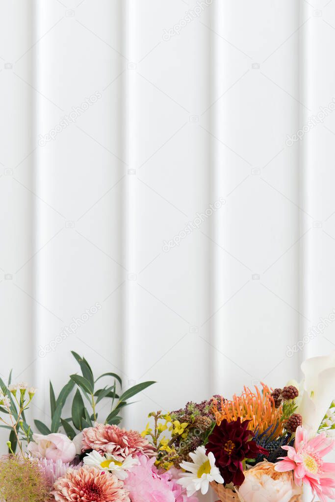 Bouquet of colorful flowers with a white wall
